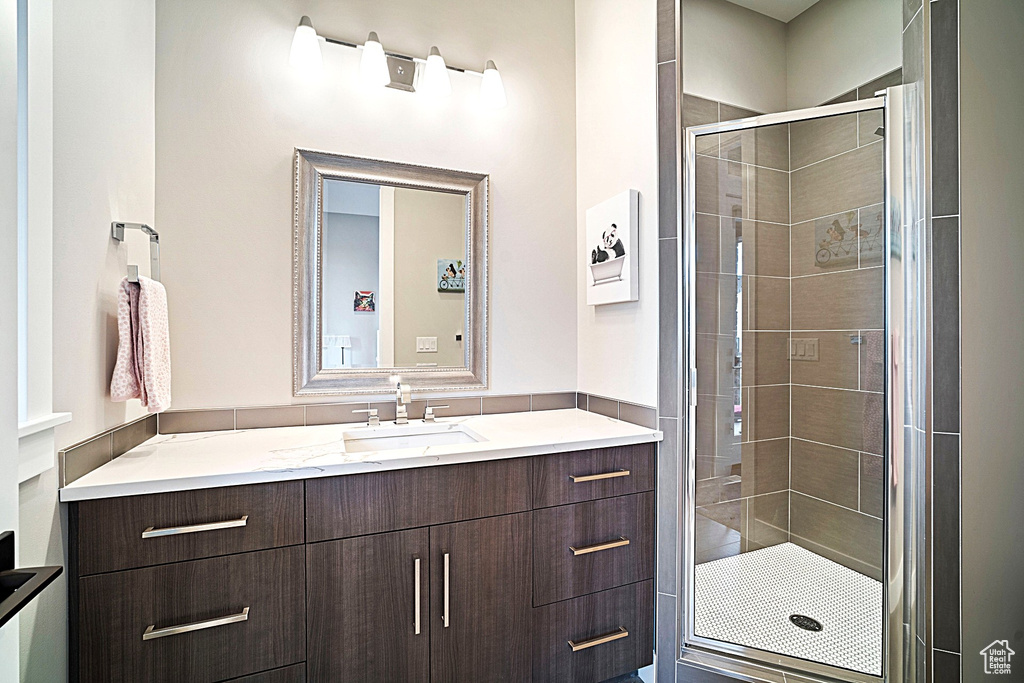 Bathroom featuring a stall shower and vanity