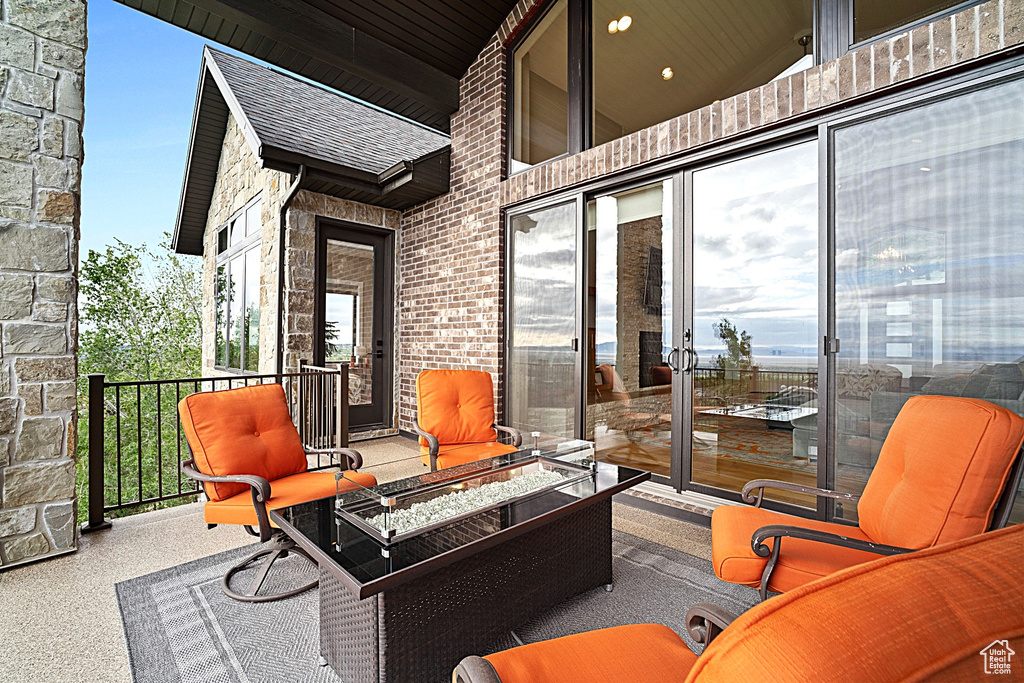 View of patio / terrace featuring a fire pit and a balcony