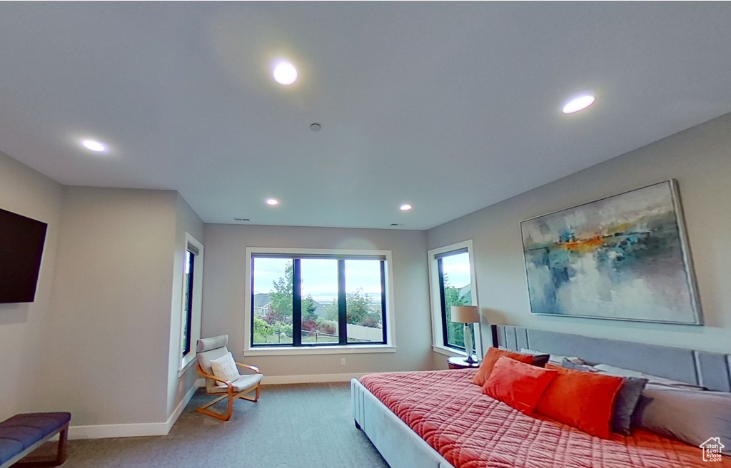 Carpeted bedroom with recessed lighting and baseboards