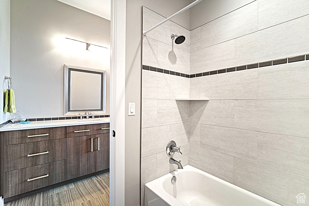 Bathroom featuring tub / shower combination and vanity