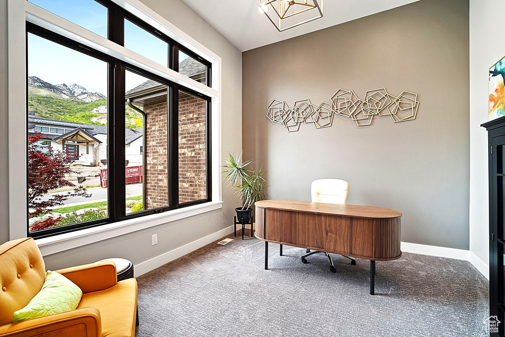 Carpeted home office with baseboards