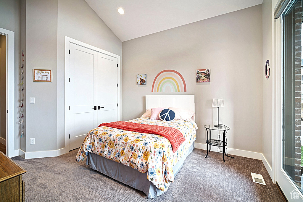 Carpeted bedroom with lofted ceiling, baseboards, a closet, and recessed lighting