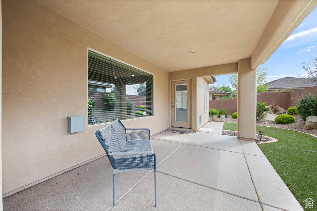 View of patio featuring fence