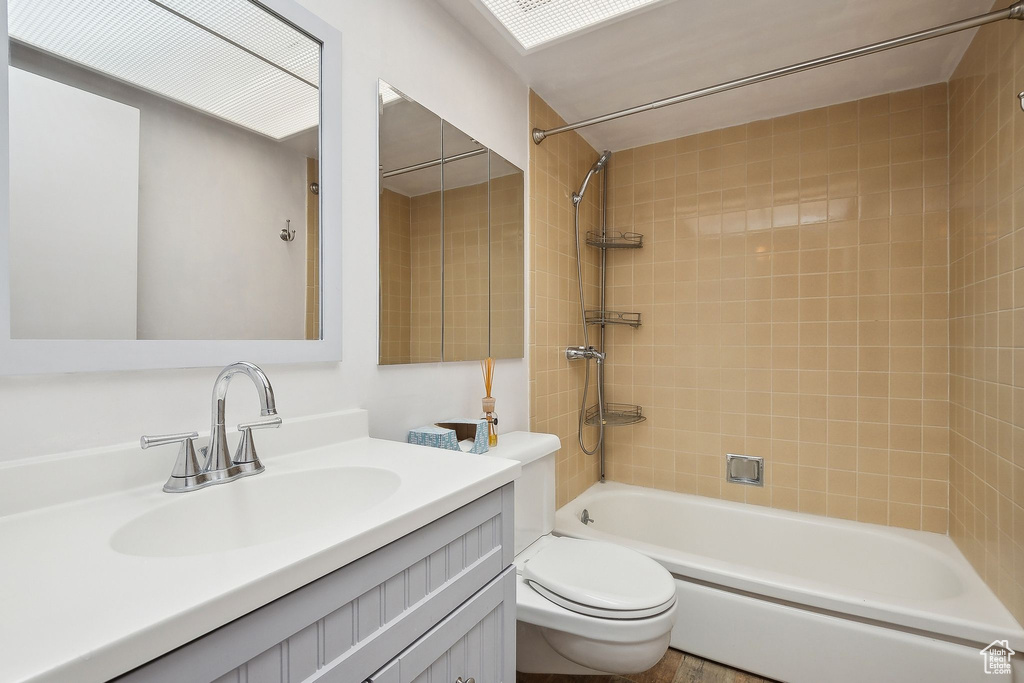Bathroom with toilet, bathing tub / shower combination, and vanity