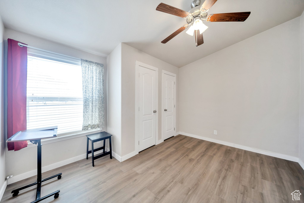 Bedroom featuring light wood-type flooring, a ceiling fan, and vaulted ceiling