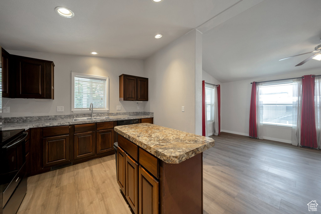 Kitchen with stainless steel range with electric cooktop, light wood-style floors, plenty of natural light, vaulted ceiling, and recessed lighting