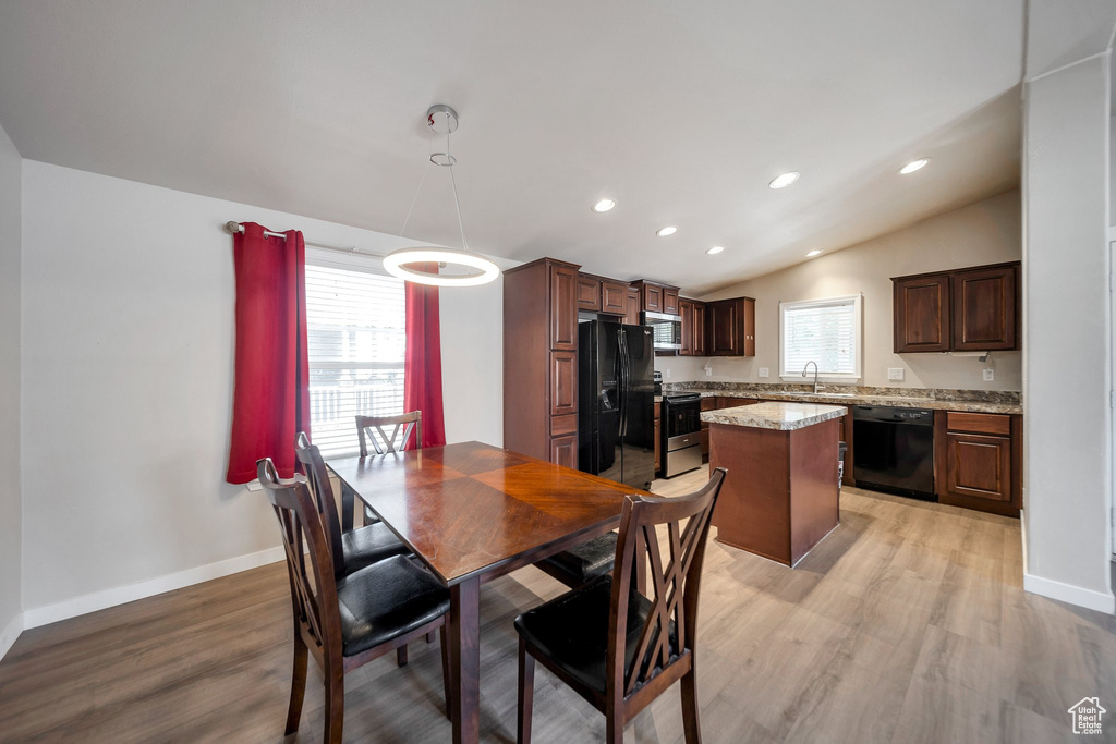 Dining area with light wood-type flooring, recessed lighting, and vaulted ceiling