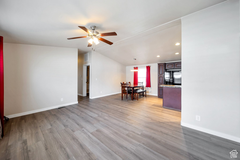 Living area featuring ceiling fan, light wood-style floors, vaulted ceiling, and recessed lighting