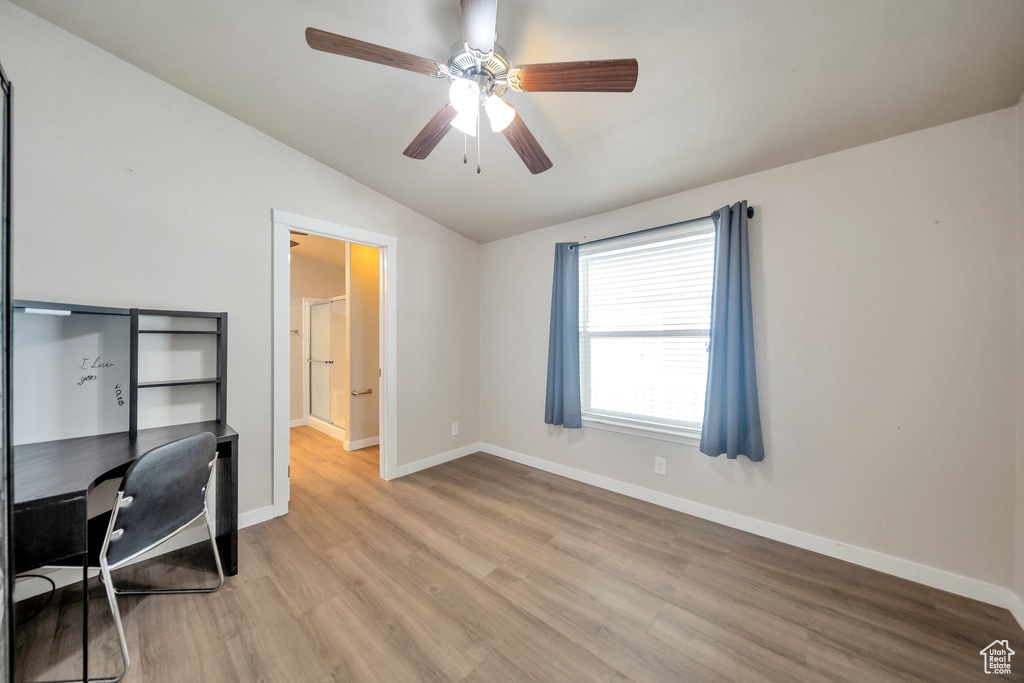 Unfurnished office with lofted ceiling, light wood finished floors, and ceiling fan