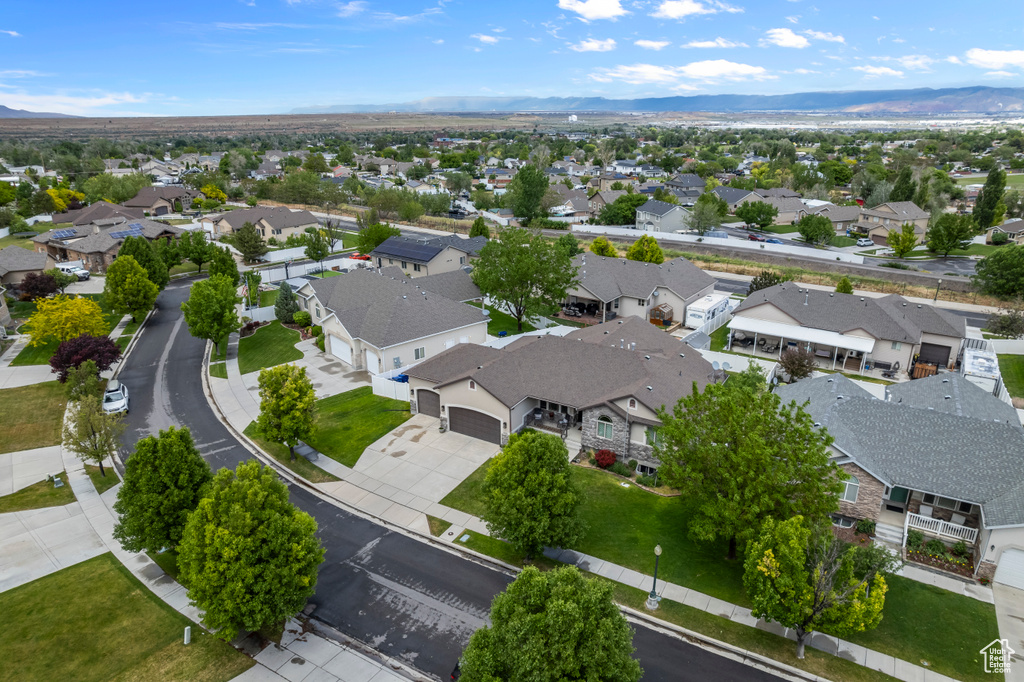 Aerial view of residential area featuring a mountainous background