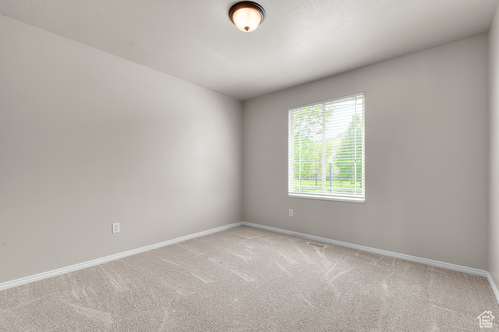 Unfurnished room with carpet and baseboards