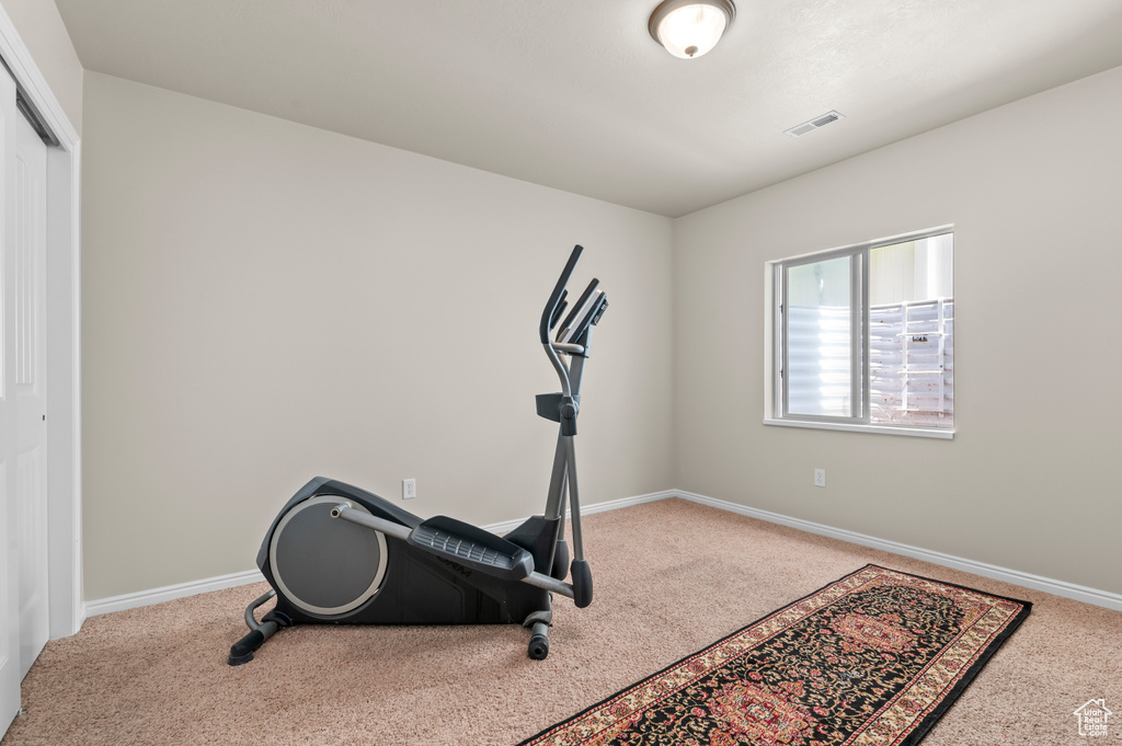 Workout area with carpet and baseboards