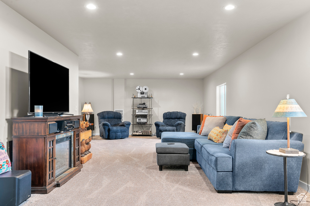 Carpeted living room with recessed lighting