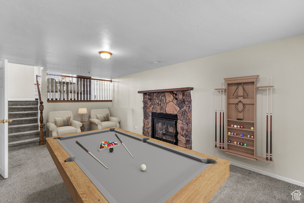 Game room with carpet floors, a fireplace, and pool table