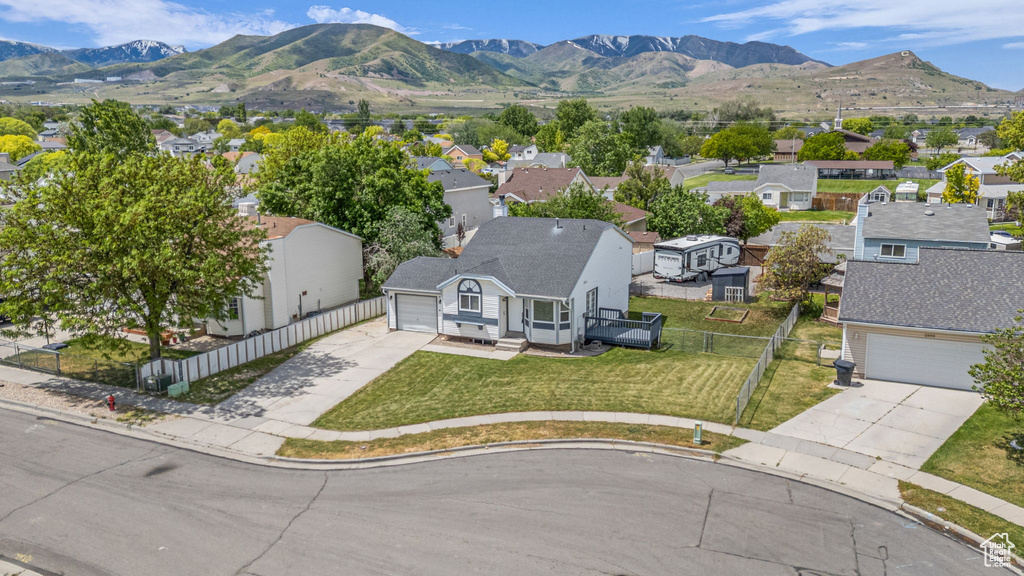 Aerial perspective of suburban area featuring a mountain backdrop