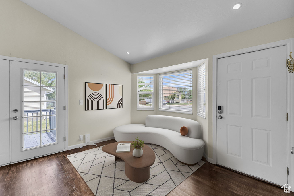 Foyer with wood finished floors, lofted ceiling, plenty of natural light, baseboards, and recessed lighting