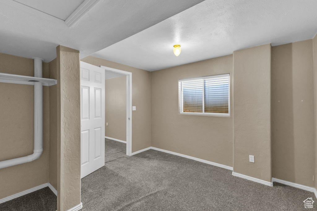 Unfurnished bedroom with carpet floors and baseboards