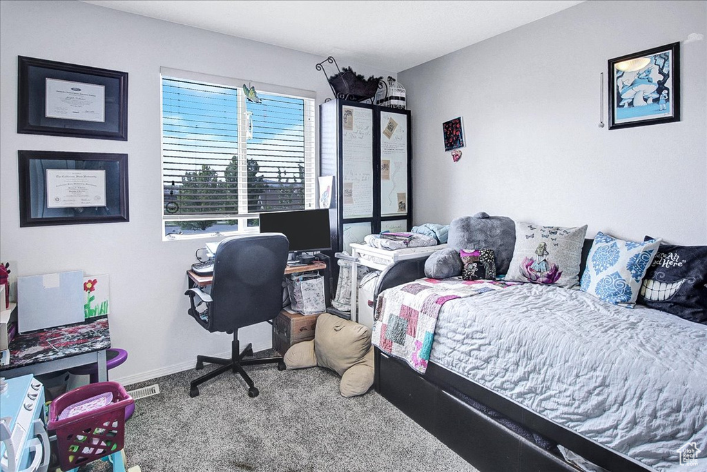 Bedroom featuring carpet floors and baseboards