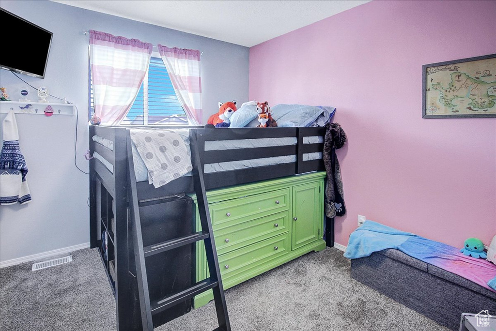 Bedroom featuring light colored carpet and baseboards