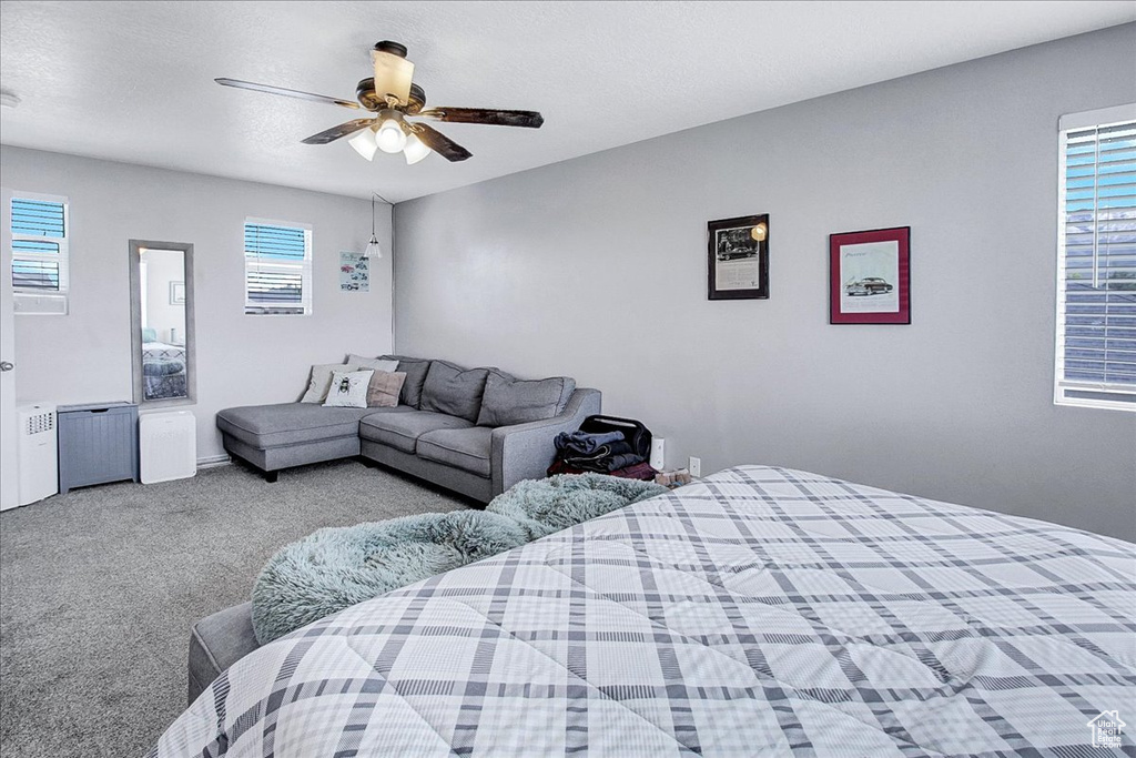 Carpeted bedroom featuring a ceiling fan