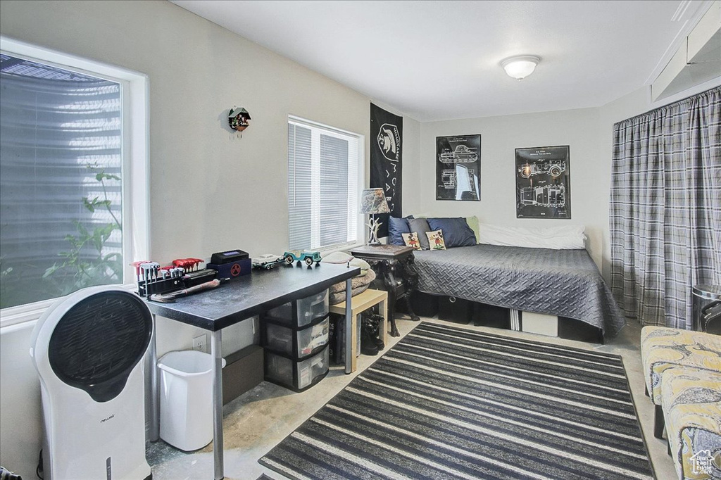 Bedroom featuring concrete flooring