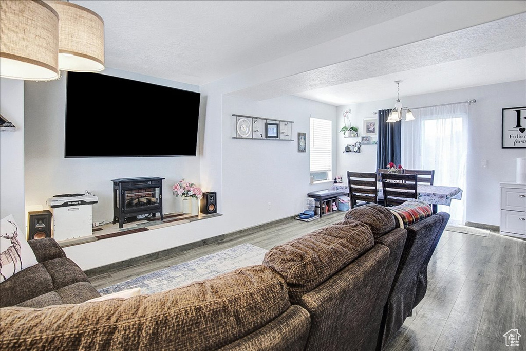 Living area with wood finished floors and a wood stove