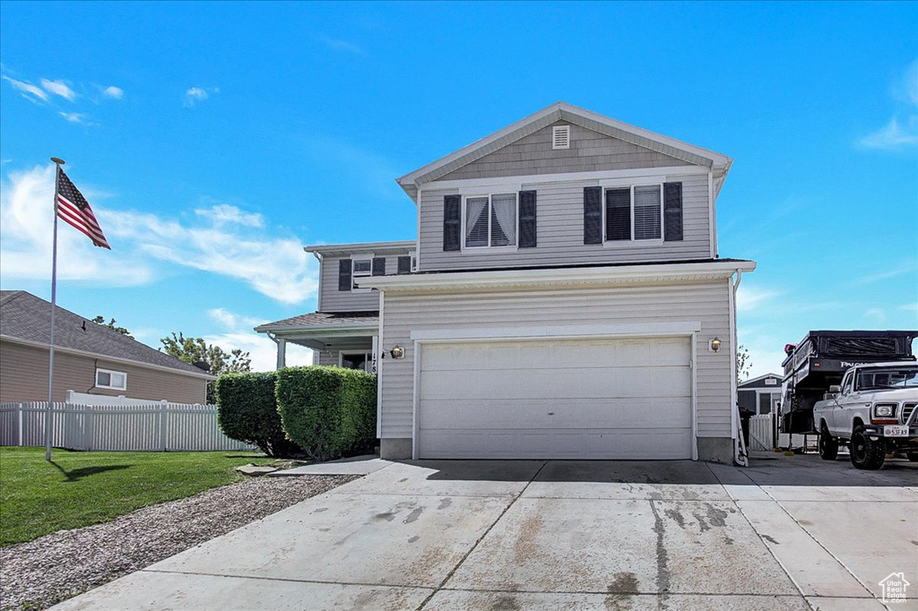 Traditional-style house featuring driveway and an attached garage