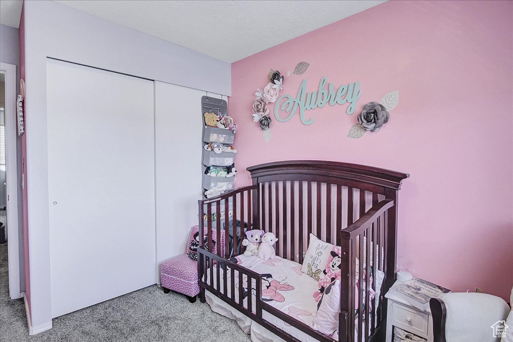 Carpeted bedroom with a closet