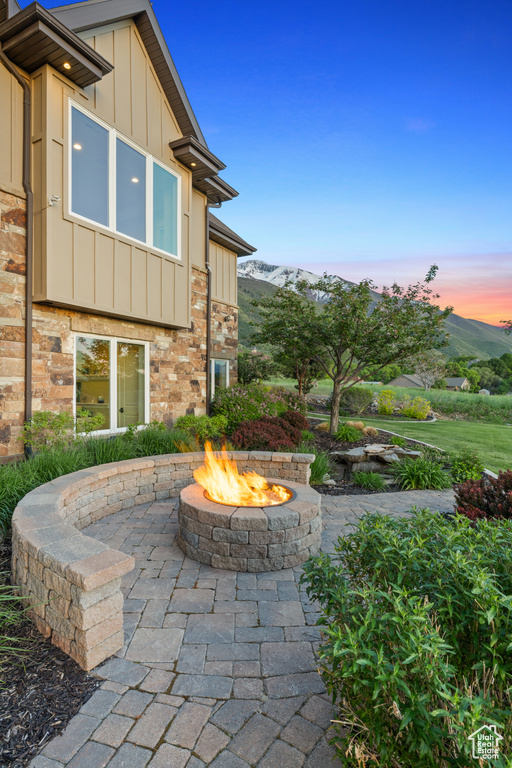 View of patio / terrace featuring an outdoor fire pit and a mountain view