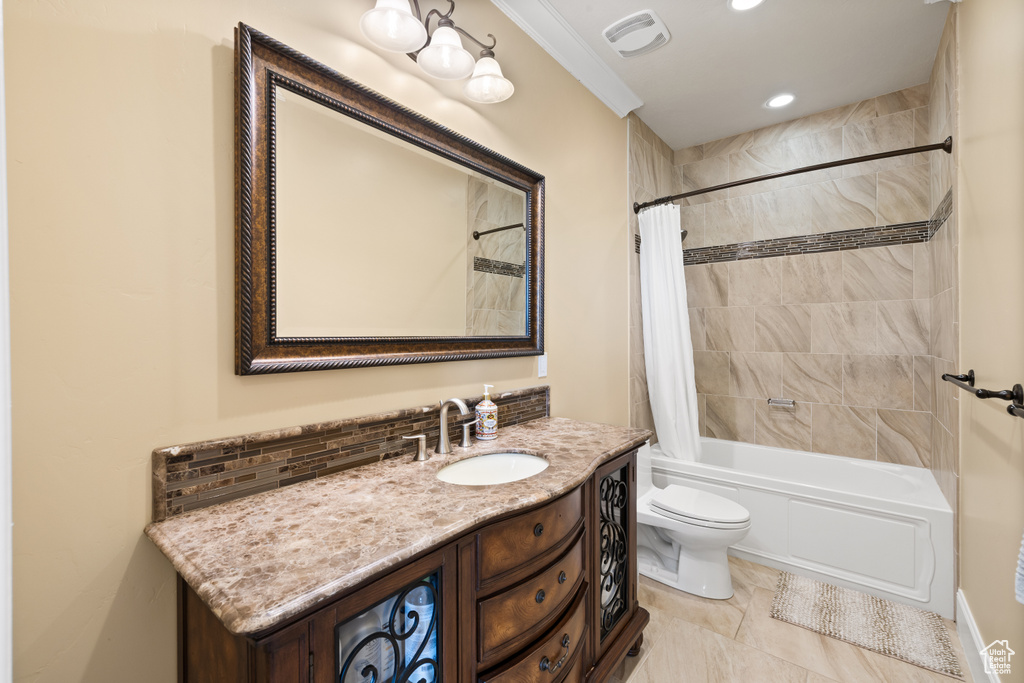 Full bath featuring toilet, shower / tub combo, vanity, recessed lighting, and ornamental molding
