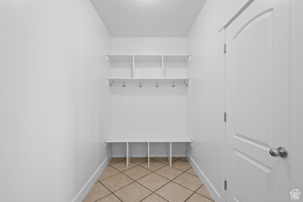 Mudroom with baseboards and light tile patterned floors