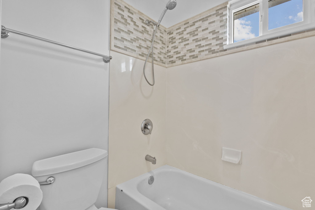Full bath featuring toilet and tub / shower combination