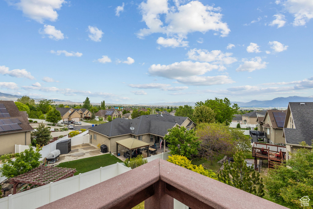 Balcony featuring a residential view and a mountain view