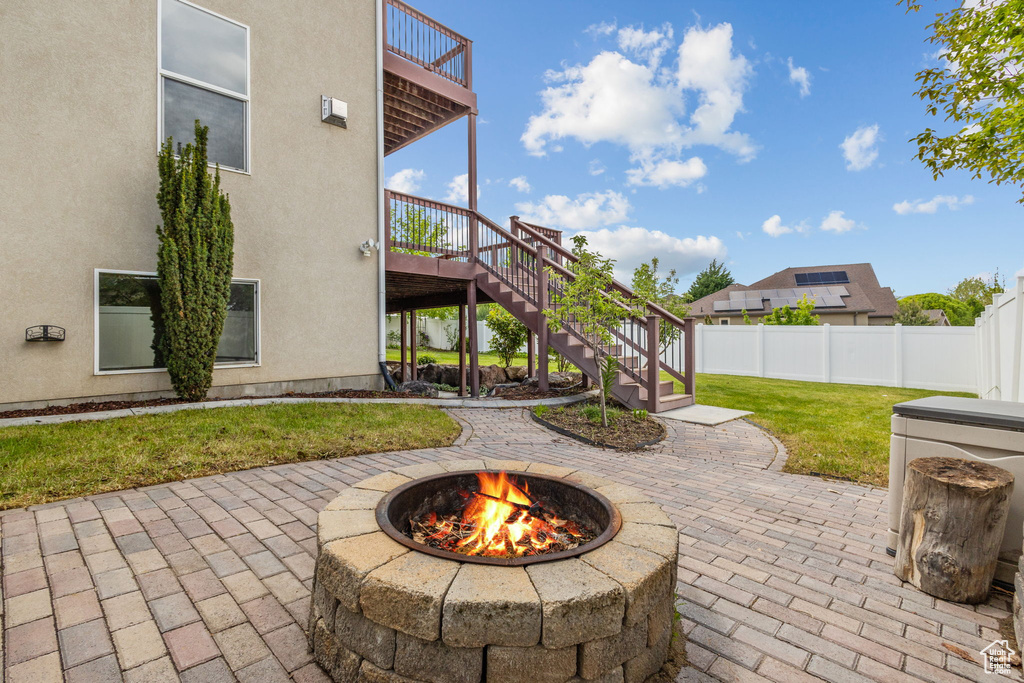 View of patio / terrace featuring a fire pit, stairs, a balcony, and a deck