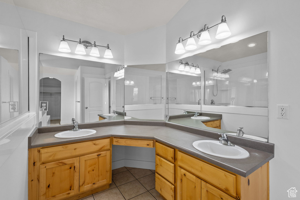 Full bathroom with double vanity and tile patterned flooring