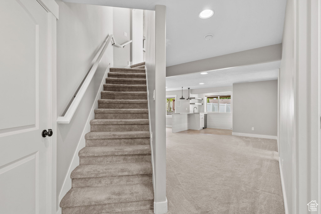 Stairs featuring carpet floors, recessed lighting, and baseboards