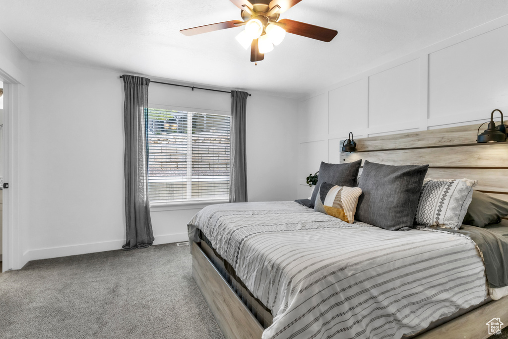 Bedroom featuring baseboards, a ceiling fan, and carpet floors