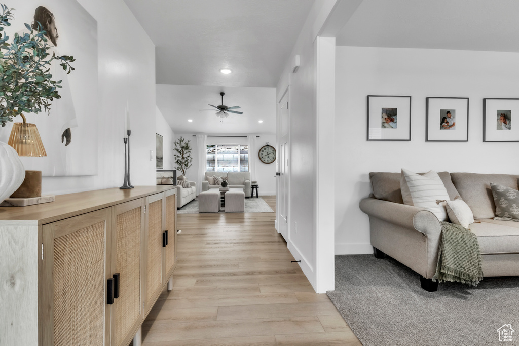 Hallway featuring light wood-style flooring, recessed lighting, and baseboards