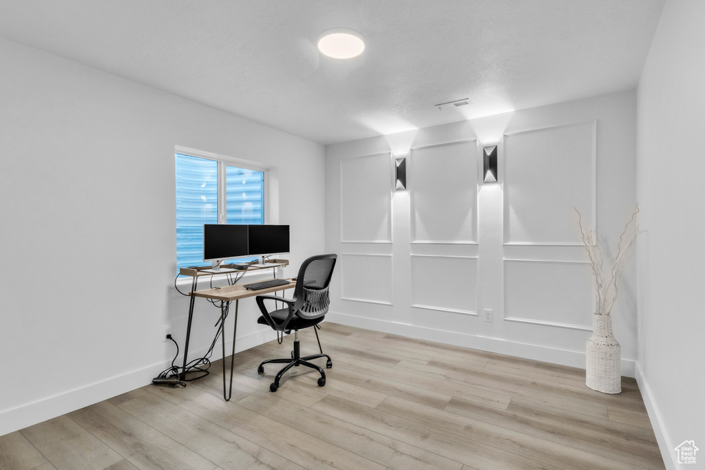 Office area featuring wood finished floors and baseboards