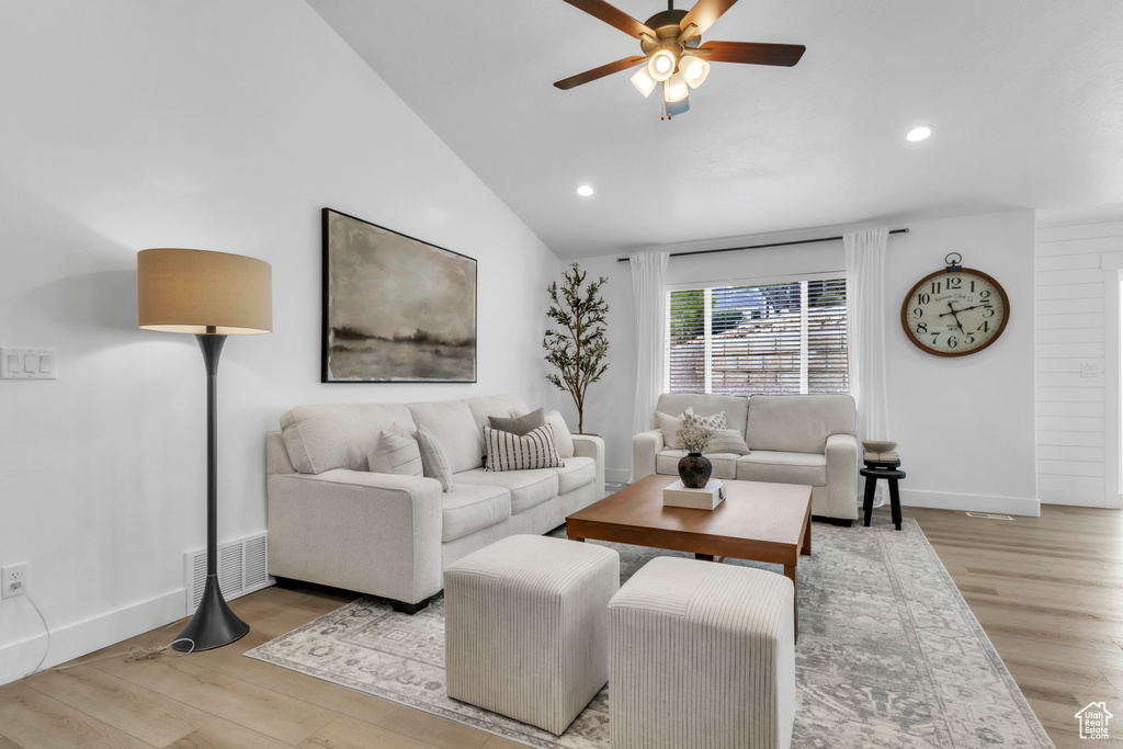 Living room featuring ceiling fan, recessed lighting, wood finished floors, lofted ceiling, and baseboards