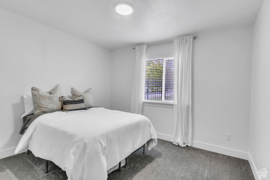 Bedroom with carpet floors and baseboards