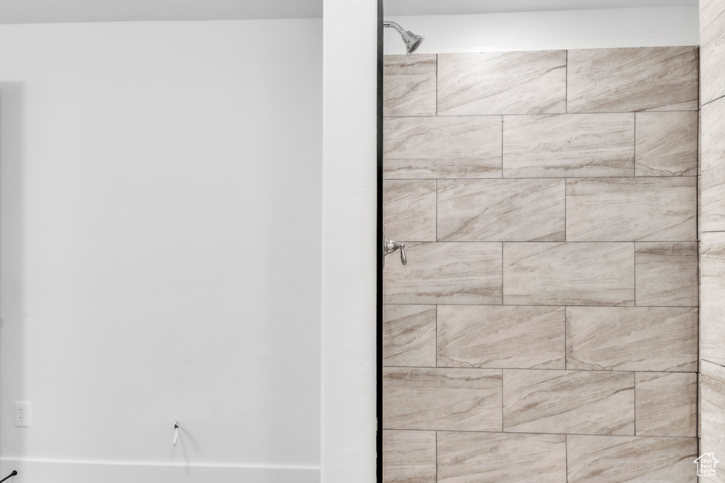 Full bath featuring a tile shower
