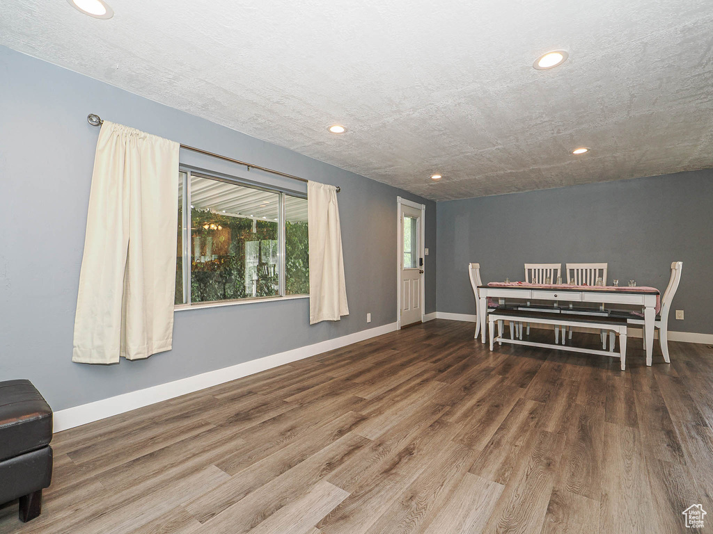 Dining room with recessed lighting, wood finished floors, and baseboards