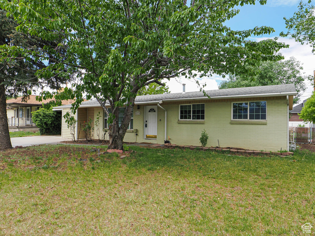 Single story home with driveway and brick siding