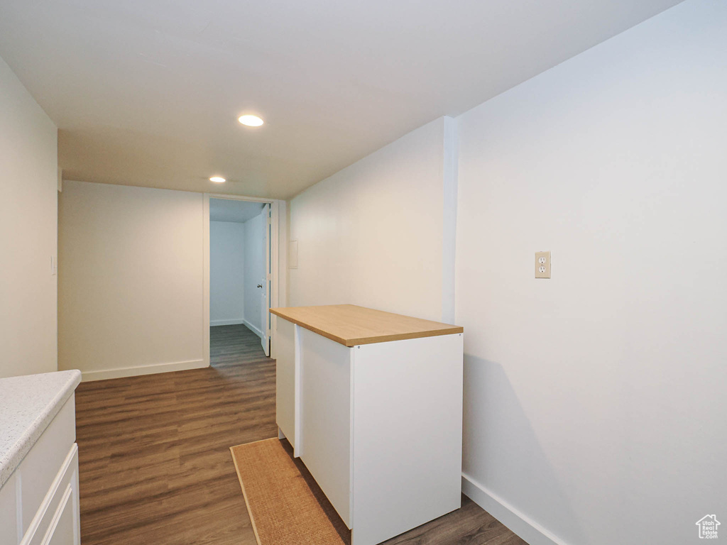 Corridor featuring recessed lighting, dark wood-style floors, and baseboards