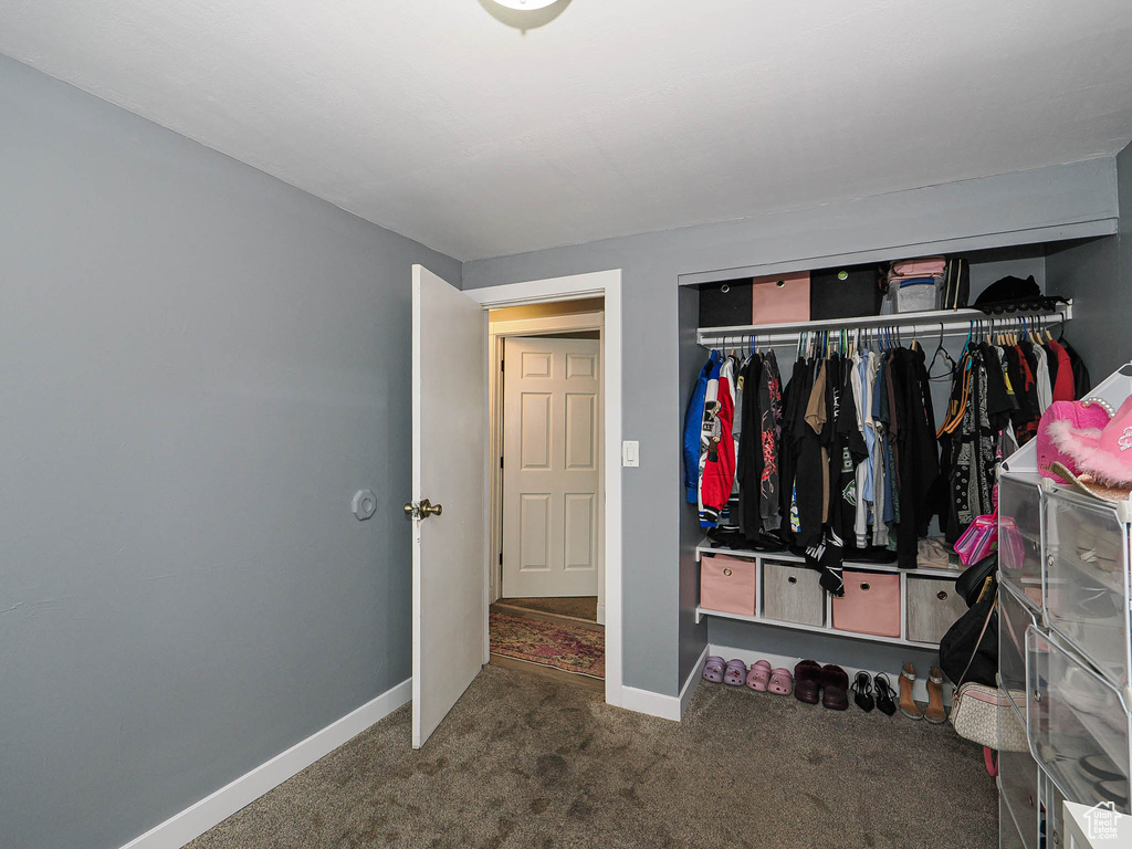 Bedroom featuring carpet floors, a closet, and baseboards