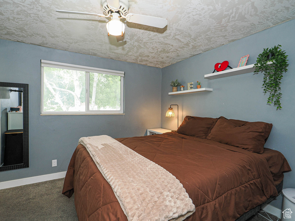 Bedroom with carpet flooring, baseboards, and ceiling fan