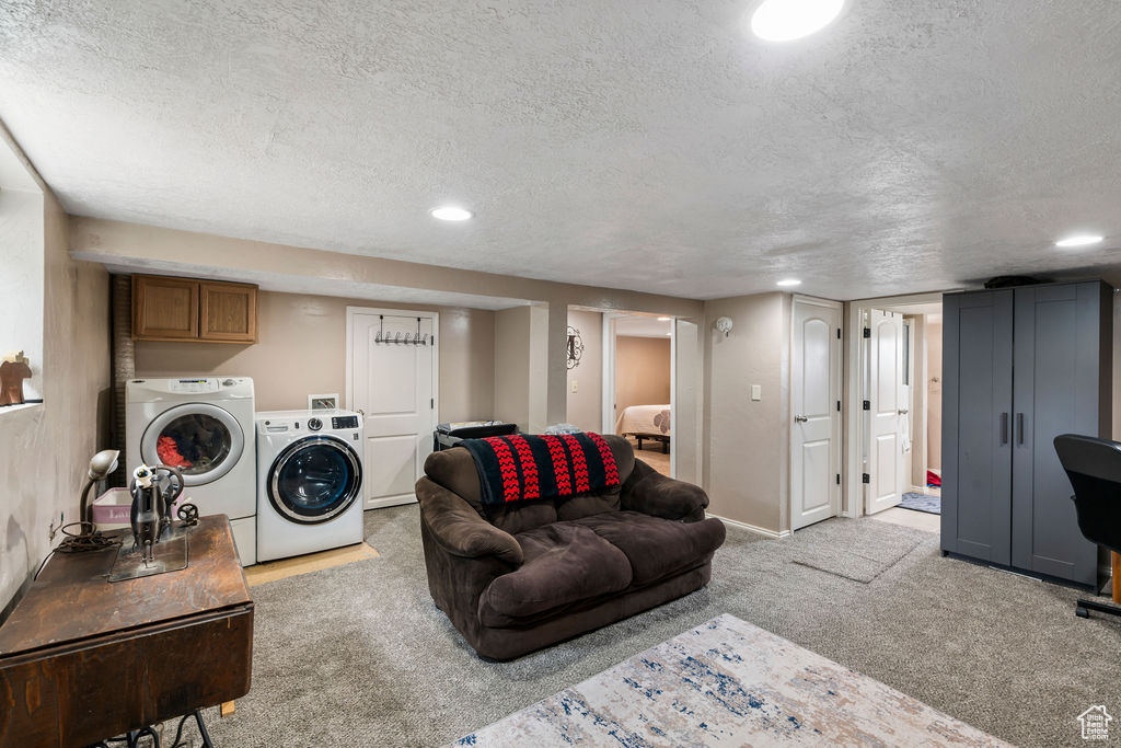 Living room with washing machine and clothes dryer, carpet, a textured ceiling, recessed lighting, and baseboards