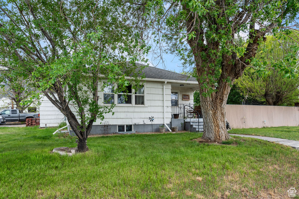 Back of property with a shingled roof