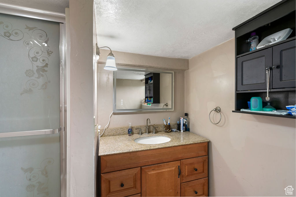 Bathroom with vanity and a textured ceiling
